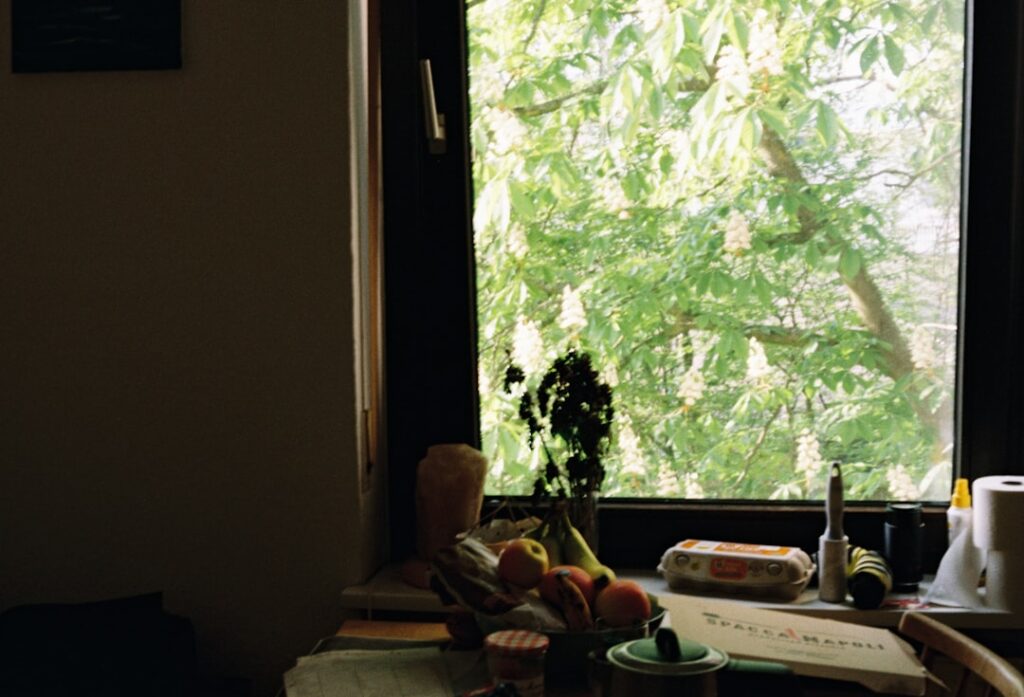 person eating breakfast by sunny window with morning light