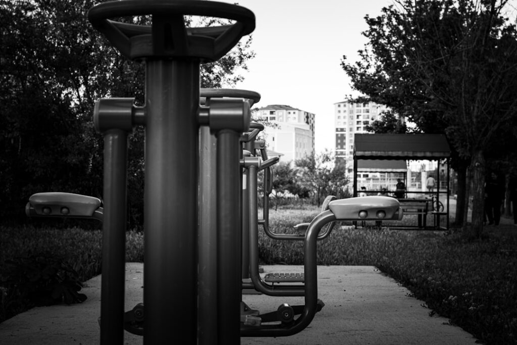 woman doing bicycle crunches on outdoor fitness area at sunset